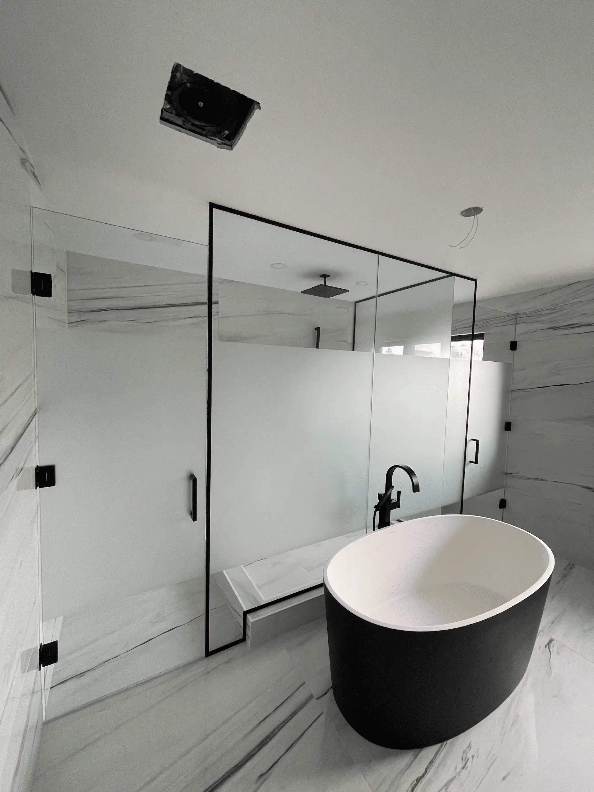 Large custom glass shower enclosure in a modern bathroom