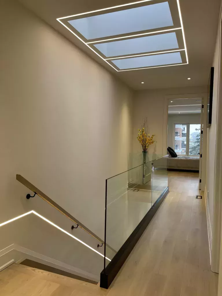 Frameless glass railing around an interior stair opening