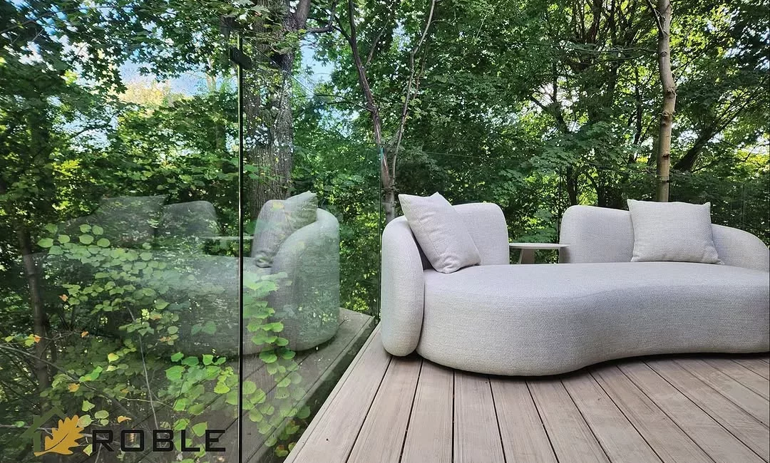 Clear glass railing installed around an elevated outdoor deck