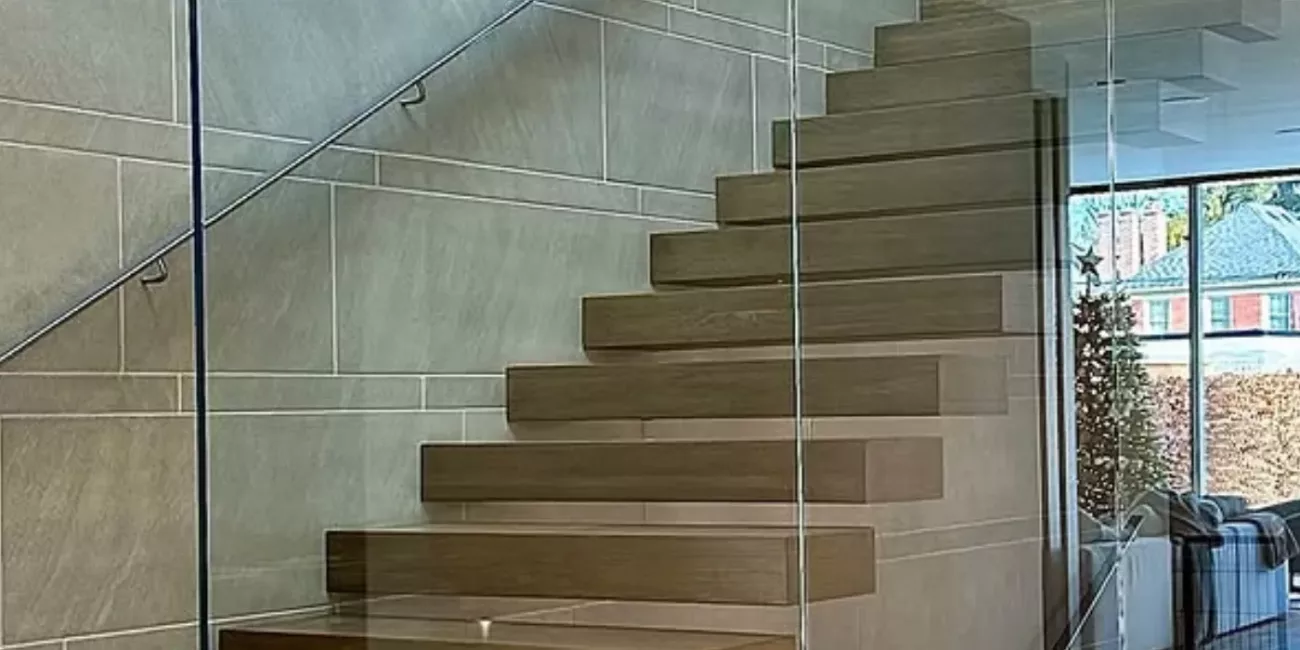 Modern wood staircase with clear frameless glass railings